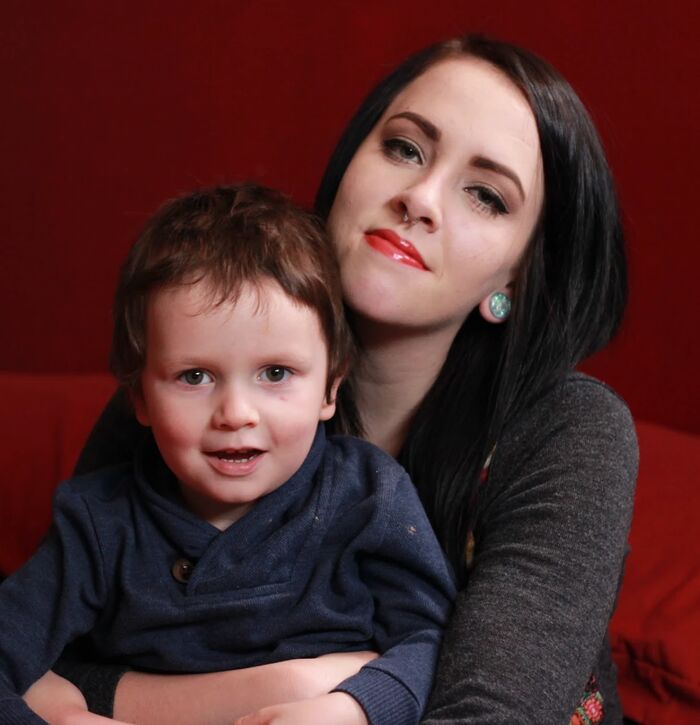 Chelsey with young Phoenix on a red couch